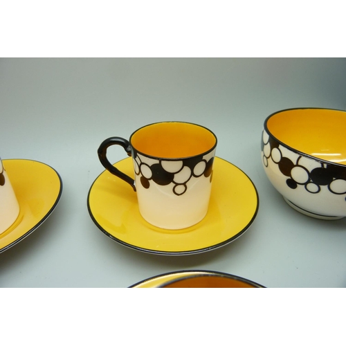 728A - A Royal Worcester six setting Art Deco coffee service, one cup cracked, with six coffee bean spoons