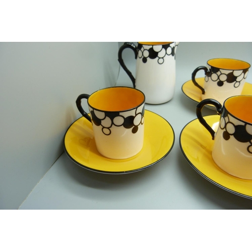 728A - A Royal Worcester six setting Art Deco coffee service, one cup cracked, with six coffee bean spoons