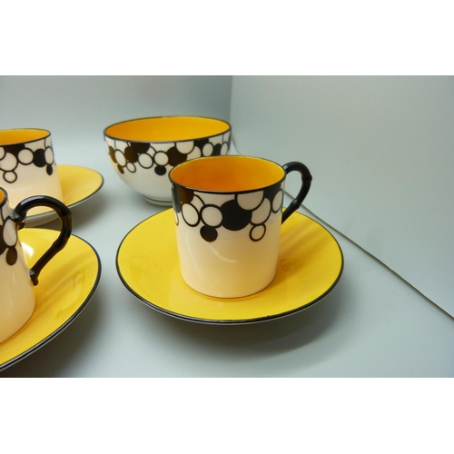 728A - A Royal Worcester six setting Art Deco coffee service, one cup cracked, with six coffee bean spoons