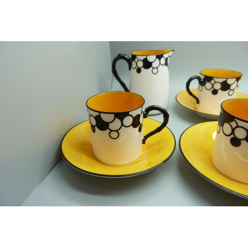 728A - A Royal Worcester six setting Art Deco coffee service, one cup cracked, with six coffee bean spoons