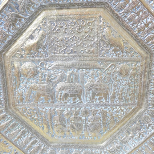 808 - An Indian embossed octagonal brass plaque, 59cm