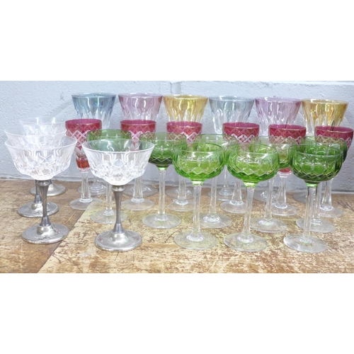 819 - Coloured drinking glasses; a set of six wine, six cranberry flash cut sherry, eight small green hock... 