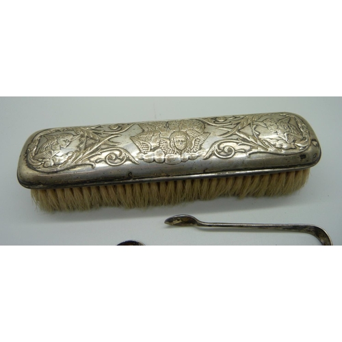 850 - A silver tea caddy spoon, a pair of silver sugar bows, a silver backed brush and two spoons