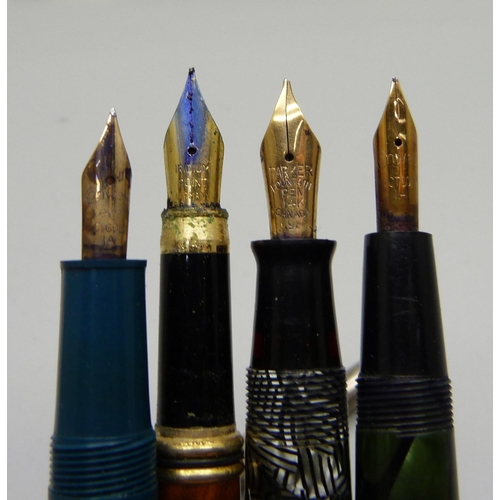 855 - Eleven 18ct rolled gold pen nibs, four pens with 14ct gold nibs, one lacking top, etc.