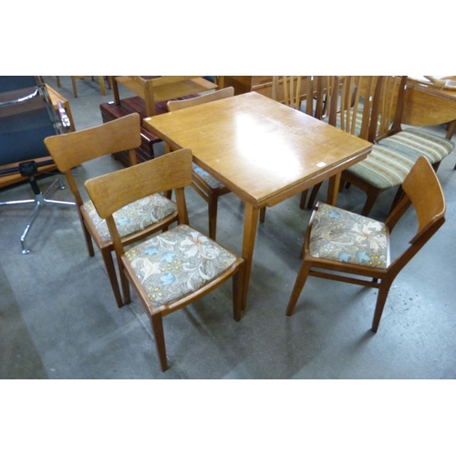 104 - An oak draw leaf dining table and four chairs