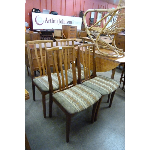 105 - A set of four teak dining chairs