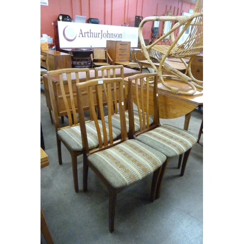 105 - A set of four teak dining chairs