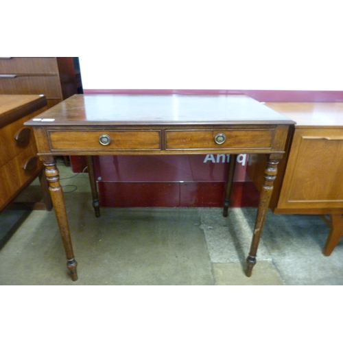 11 - A Victorian mahogany two drawer writing table