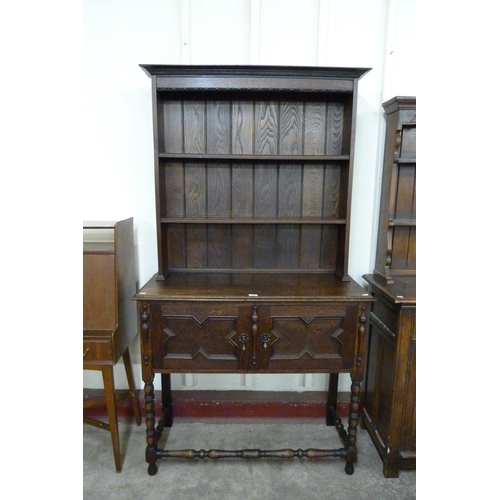 123 - A 17th Century style oak geometric moulded dresser