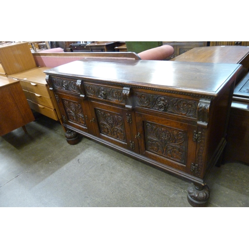 140 - A 17th Century style Jaycee carved oak sideboard