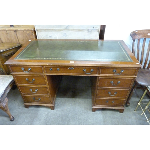 167 - A yew wood and green leather topped pedestal desk