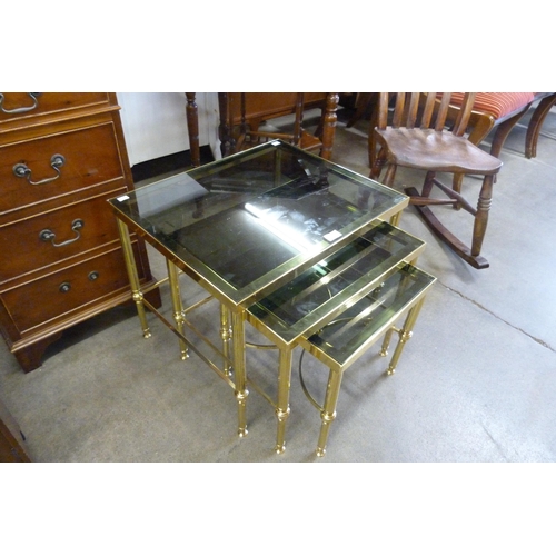 173 - An Italian brass and glass topped nest of tables