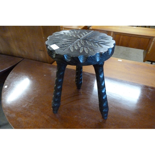 176 - A carved softwood stool