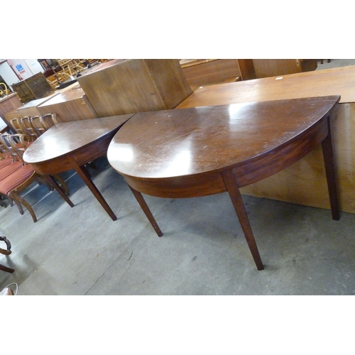 180 - A pair of George IV mahogany demi-lune console tables