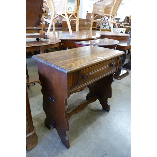 182 - A carved oak single drawer side table