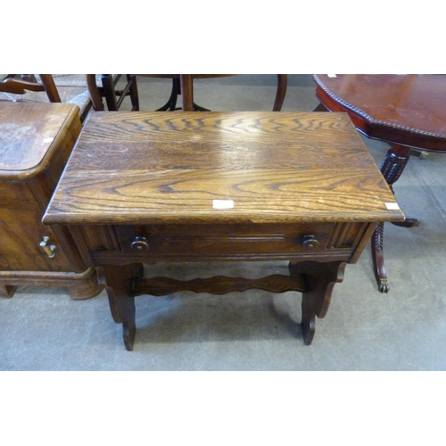 182 - A carved oak single drawer side table