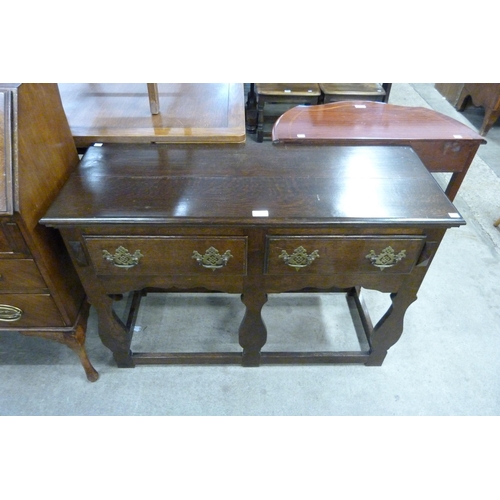 190 - A small George III style oak two drawer dresser