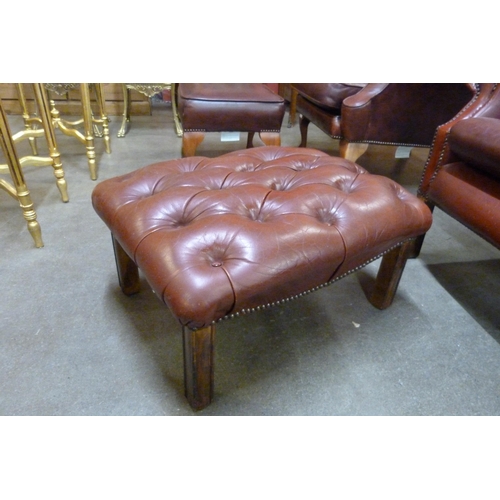 20 - An oxblood red leather Chesterfield footstool