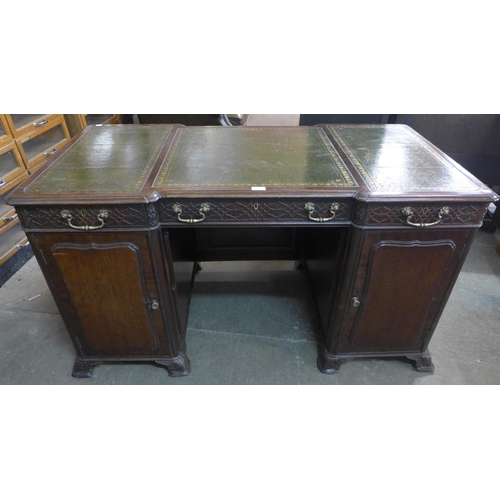 206 - A Victorian Chipendale Revival carved mahogany and green leather topped library desk