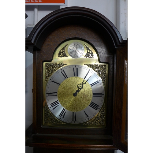 208 - An oak triple weight longcase clock