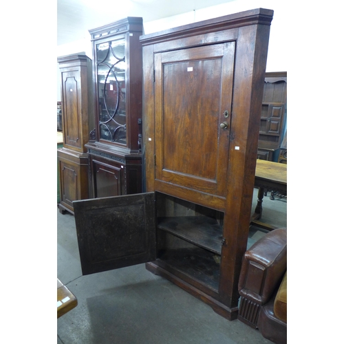 213 - A George III elm freestanding corner cupboard