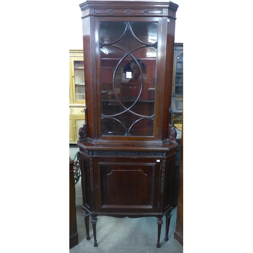 214 - An Edward VII carved mahogany freestanding splay front corner cabinet