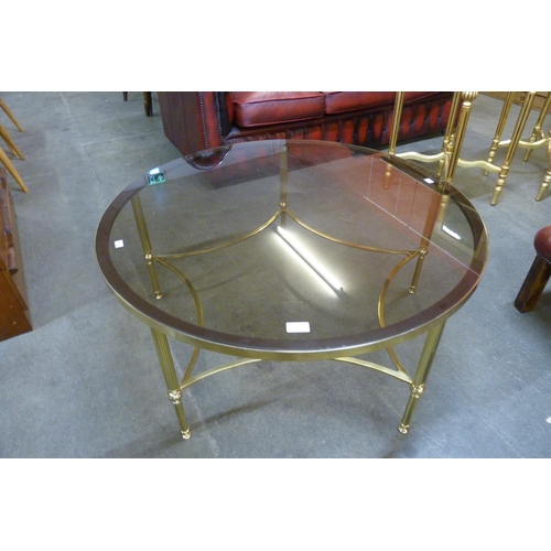 22 - An Italian brass and glass topped circular coffee table