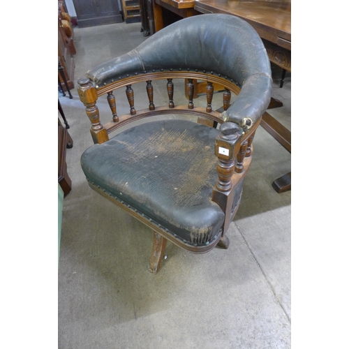 220 - A Victorian oak and upholstered revolving Captain's desk chair