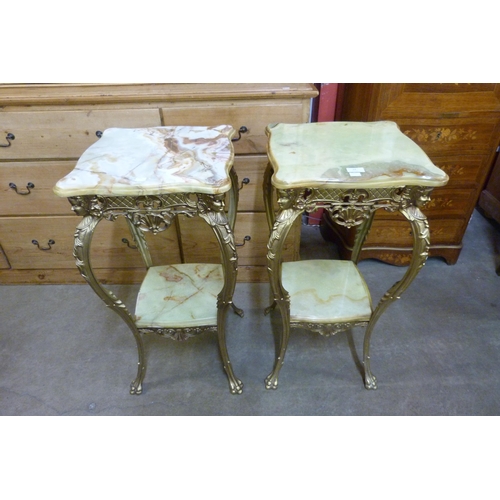 24 - A pair of French gilt metal and onyx two tier etageres