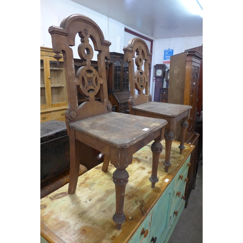 252 - A pair Victorian Gothic Revival Thomas Simpson mahogany hall chairs