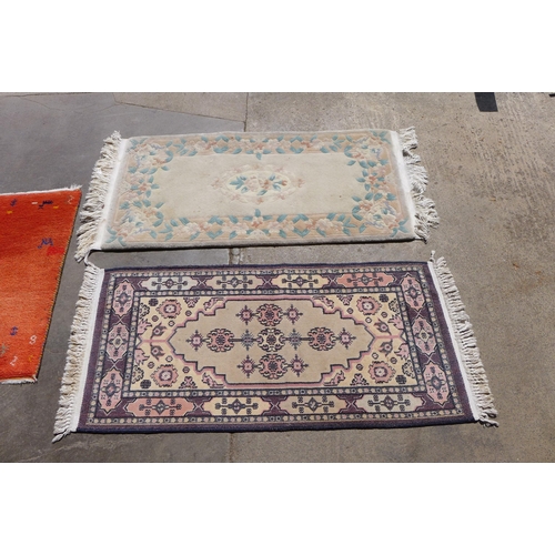 261 - An eastern hand knotted rug, a Chinese rug and a mat