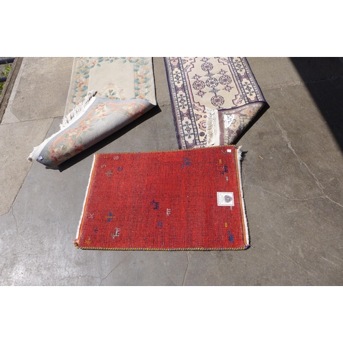 261 - An eastern hand knotted rug, a Chinese rug and a mat