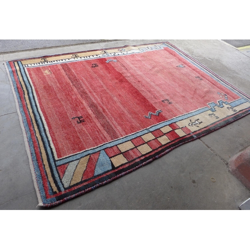 263 - An Iranian red ground woollen Gebbeh rug