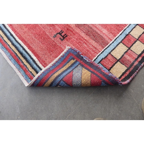 263 - An Iranian red ground woollen Gebbeh rug