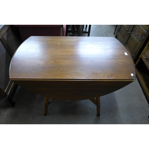 265 - An Ercol Golden Dawn elm drop leaf table