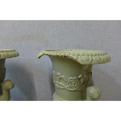 302 - A pair of Victorian cast iron campana garden urns on stands