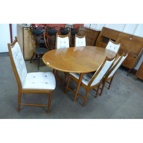 35 - A teak extending dining table and six chairs