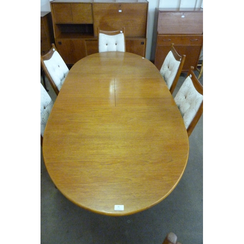 35 - A teak extending dining table and six chairs