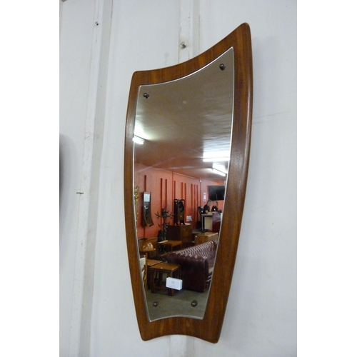 38 - An asymmetrical teak framed mirror