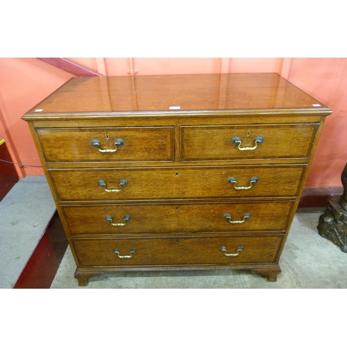 5 - A George III oak and mahogany crossbanded chest of drawers