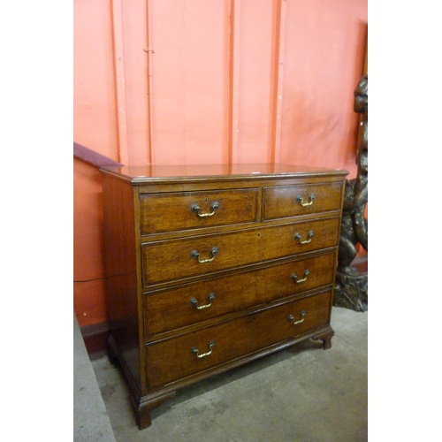 5 - A George III oak and mahogany crossbanded chest of drawers