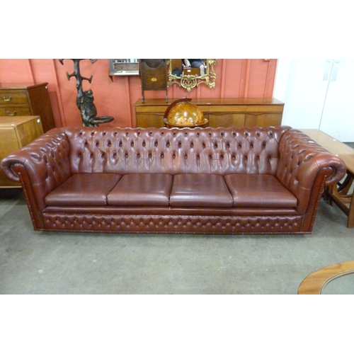 6 - An oxblood red leather Chesterfield settee