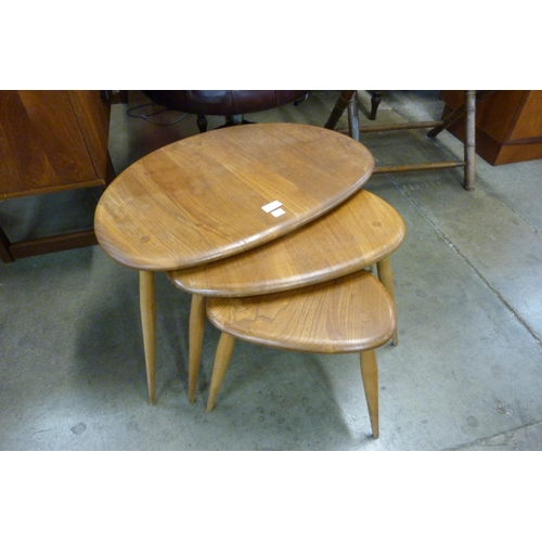 64 - An Ercol Blonde elm and beech pebble shaped nest of tables