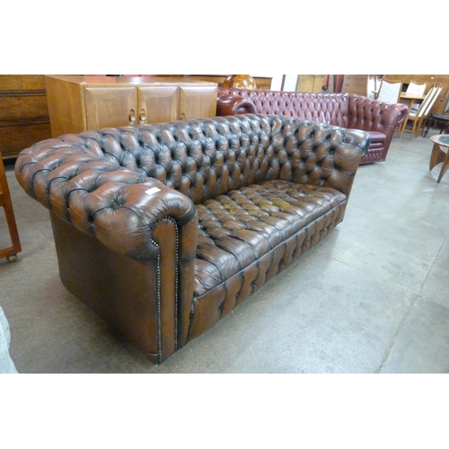 7 - A chestnut brown leather Chesterfield settee