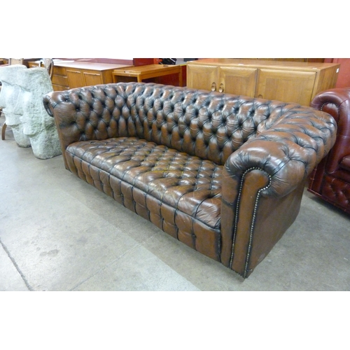 7 - A chestnut brown leather Chesterfield settee