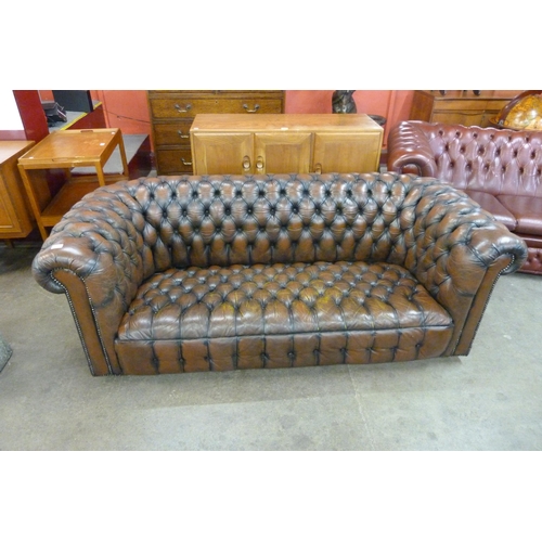 7 - A chestnut brown leather Chesterfield settee