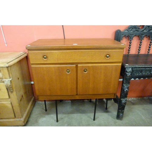 79 - A teak cabinet on black metal stand