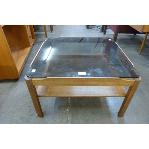 83 - A Myer teak and glass topped square coffee table