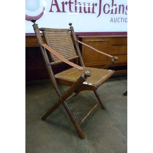 9 - A Victorian campaign style faux bamboo and bergere folding chair