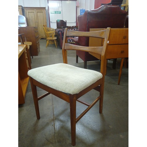 77 - A teak extending dining table and four chairs